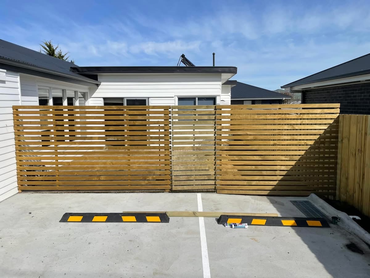 Horizontal timber slat fence and matching gate at a Tasmanian home