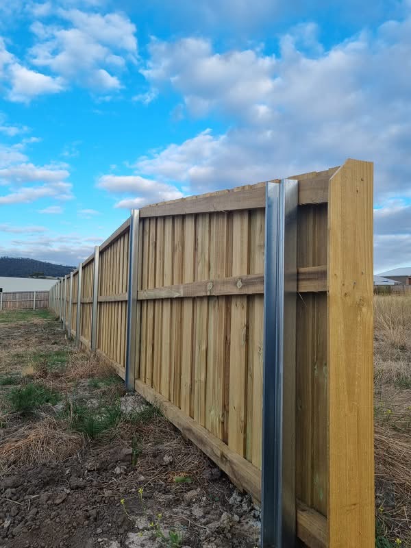 Timber paling fence with galvanised steel posts on a rural block