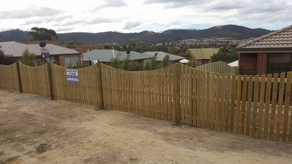 Timber picket fence with curved tops along a new suburban block